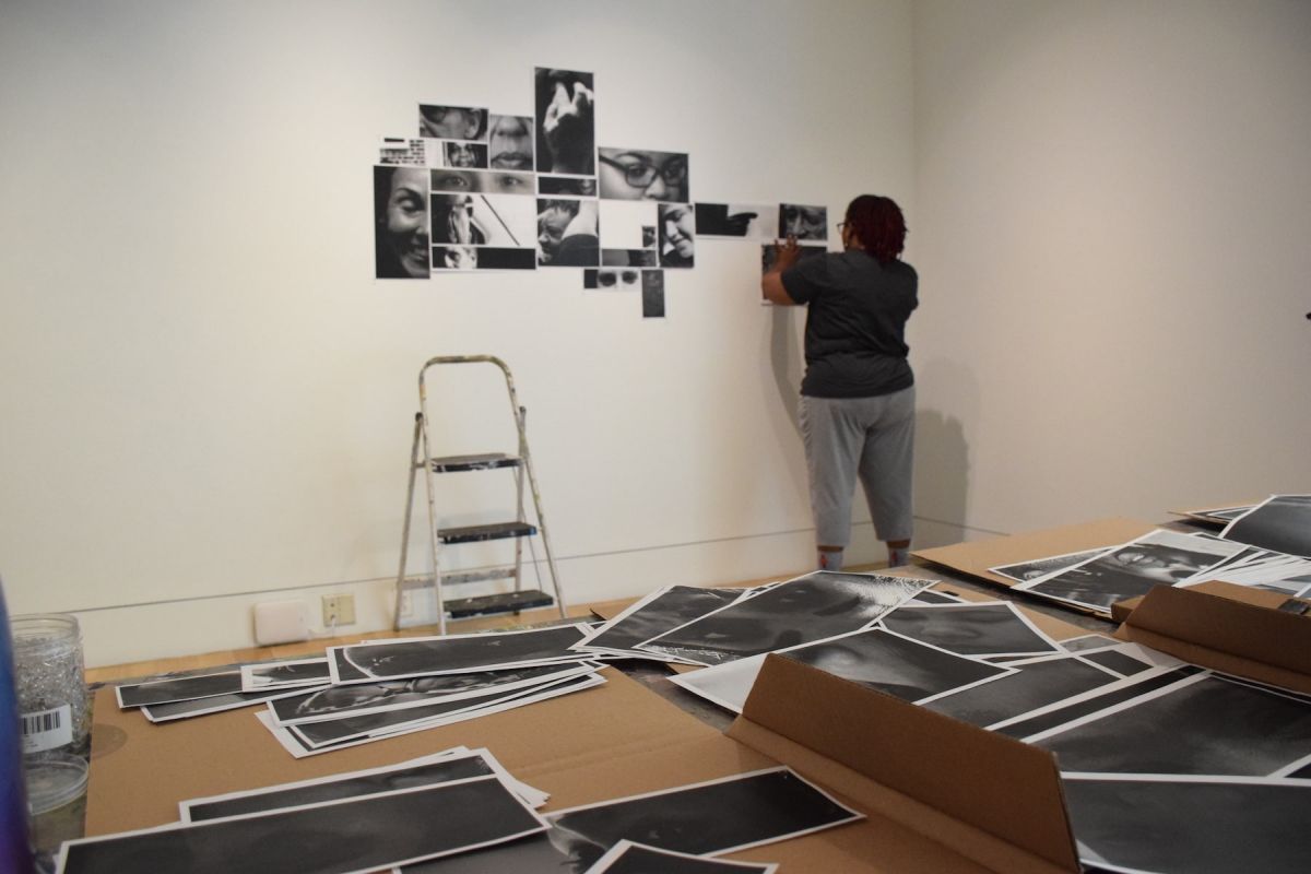 Lyn Townes (MFA '19) installs work in the School of Fine Arts gallery.