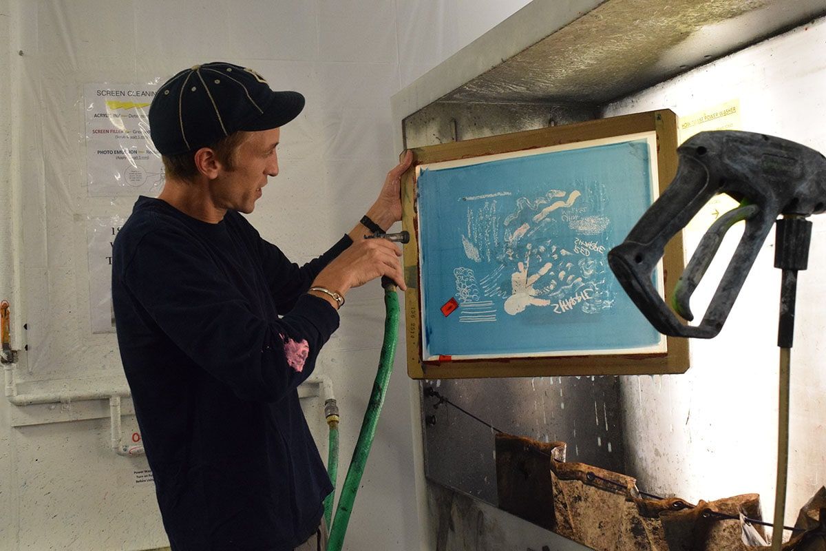 Mike Kondel (MFA '19) washes a screen in the print shop.