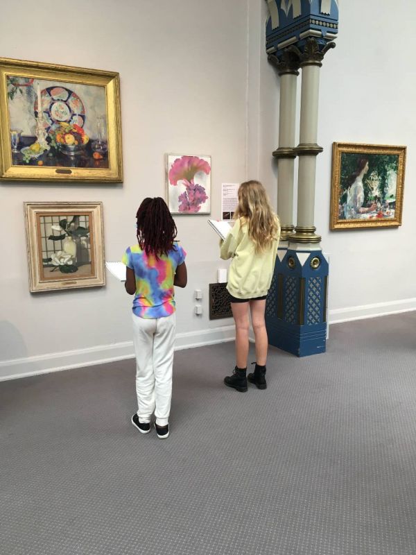 two campers sketching in the galleries