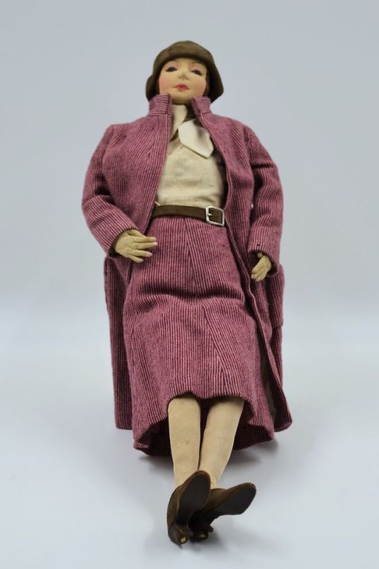 Handmade soft cloth doll in a mauve dress suit.