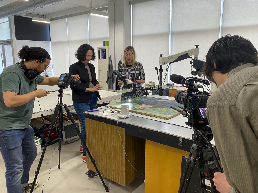 Videographer filming conversation between Beth and Ali
