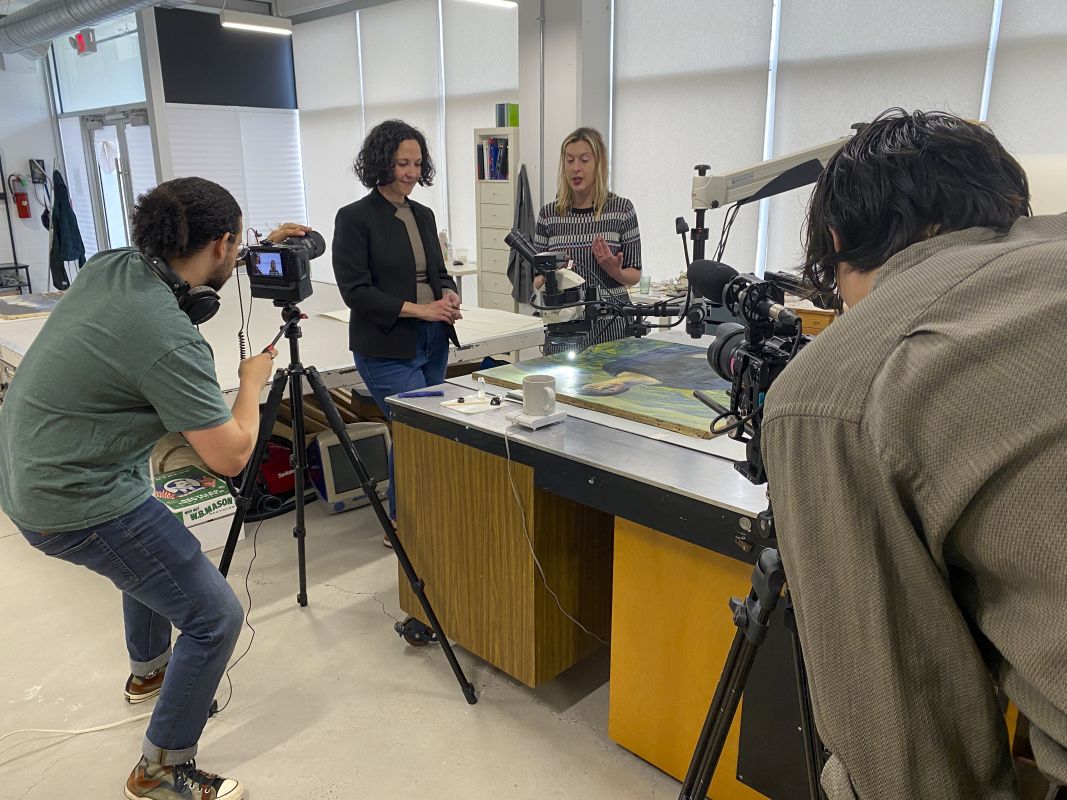 Videographer filming conversation between Beth and Ali
