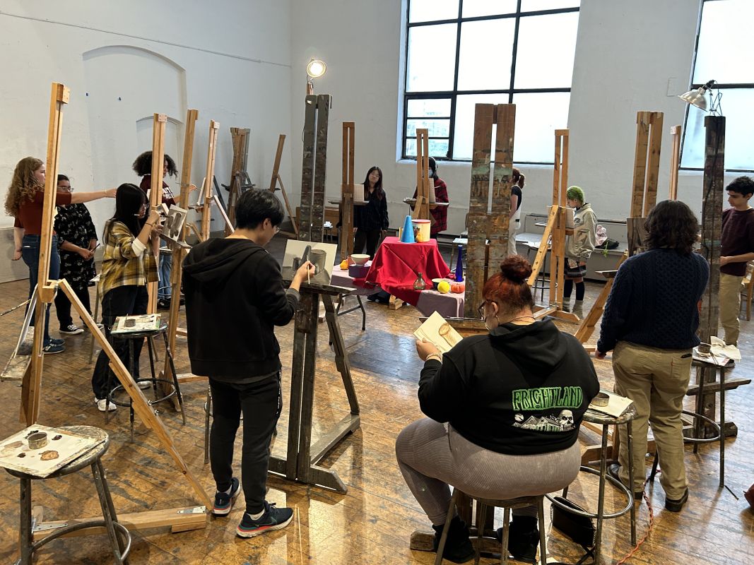 Students refine their technique and attention to detail in still life painting, focusing on light, shadow, and texture