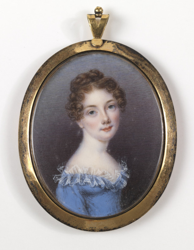 Oval portrait miniature of a young person with curly hair in a blue dress with lace trim, set in a gold frame. The expression is calm and serene.