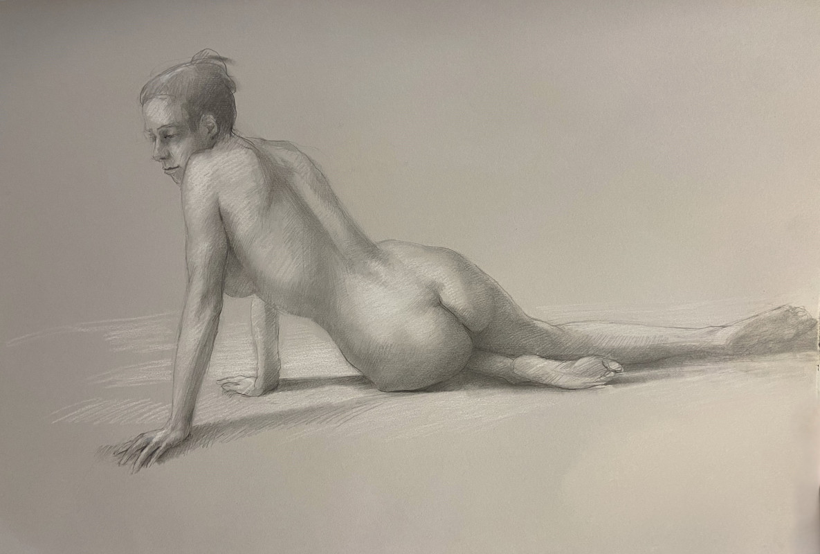 A monochrome graphite figure drawing depicts a nude individual reclining on the ground, leaning on one arm with their back and torso turned toward the viewer.