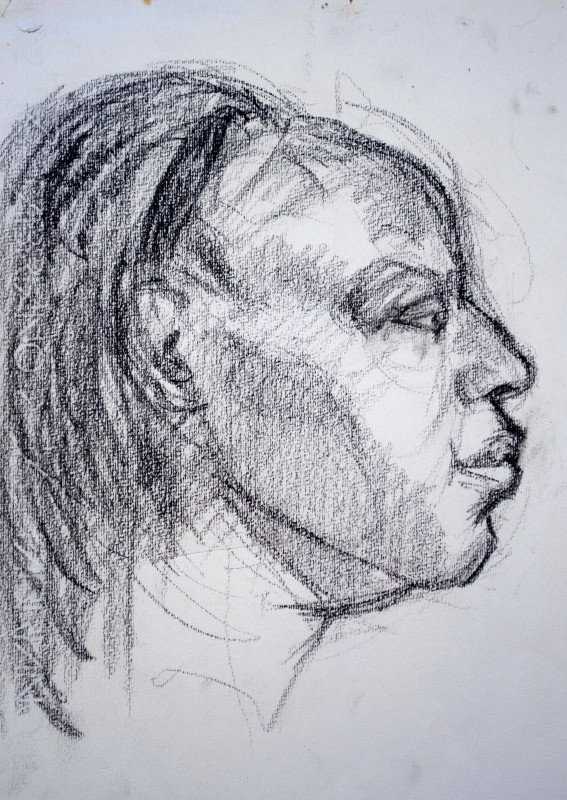 A charcoal profile sketch capturing the side of a person's face with expressive shading and loose contour lines.