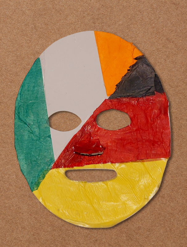 An oval, textured face mask is constructed from sections representing different national flags, including the green, white, and orange of Ireland alongside the black, red, and yellow of Germany.