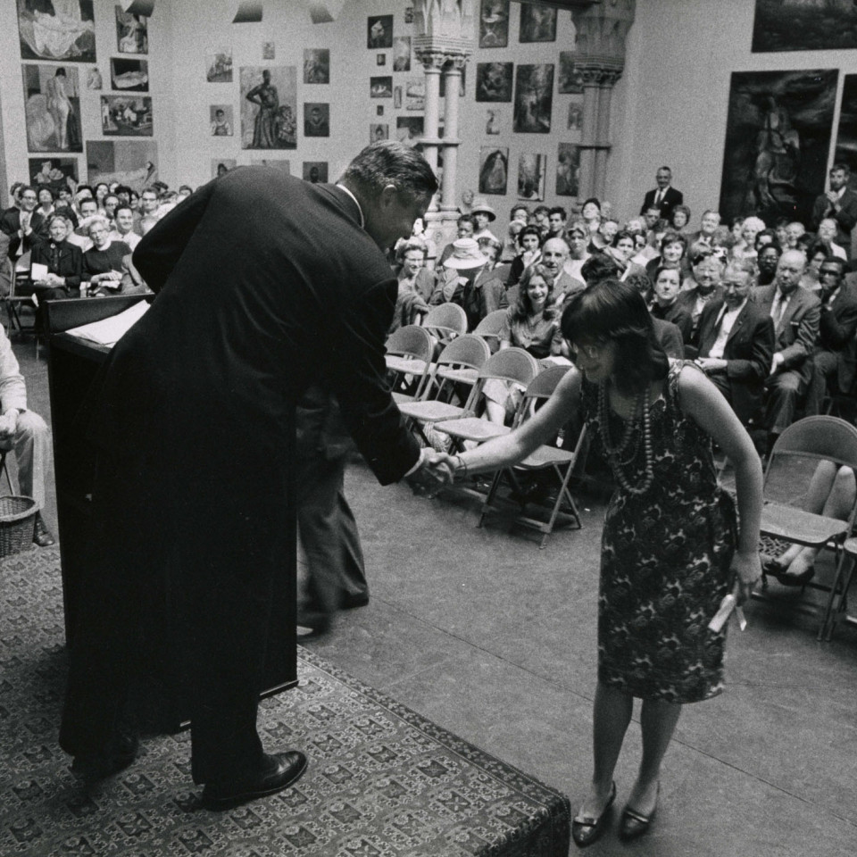 black and white photo of a student receiving an award