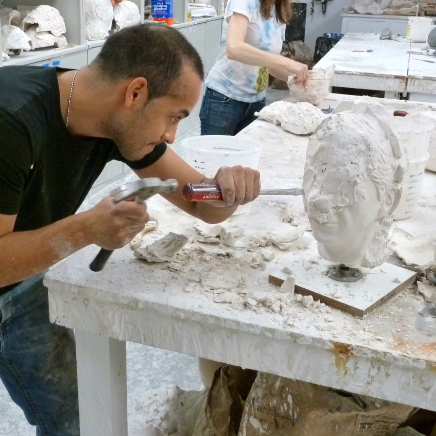  a sculptor working on a portrait bust