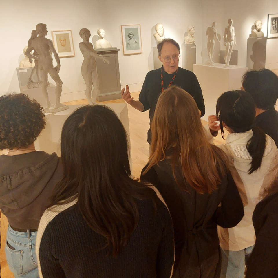 An educator leading students on a tour