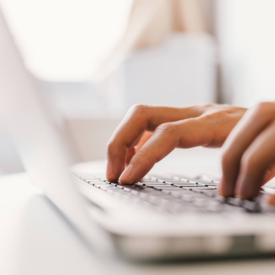 hands typing at a computer