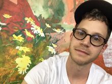 close up of Doron Langberg in front of painting detail