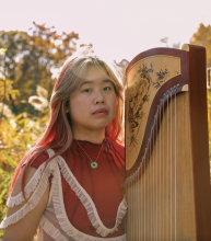 portrait of Salina Kuo with a guzheng.