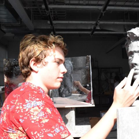 Summer Academy student Max Brenneman works on a sculpture during class.