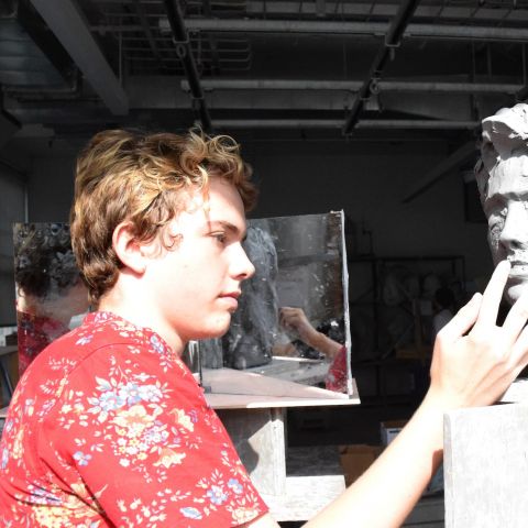 Summer Academy student Max Brenneman works on a sculpture during class.