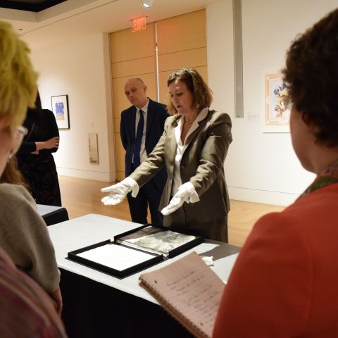 Brodsky Center Director Paola Morsiani guides visitors through a print portfolio