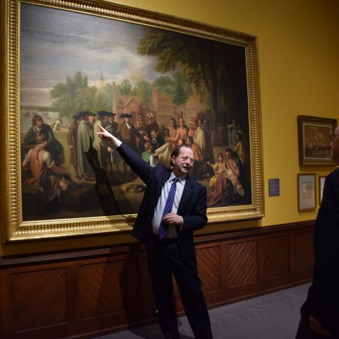 David Brigham, CEO and President of PAFA, guides visitors through a painting