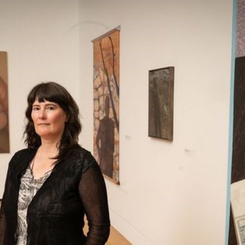 Clarity Haynes, with her painting "Janie" (left), at the “Taking Space:
