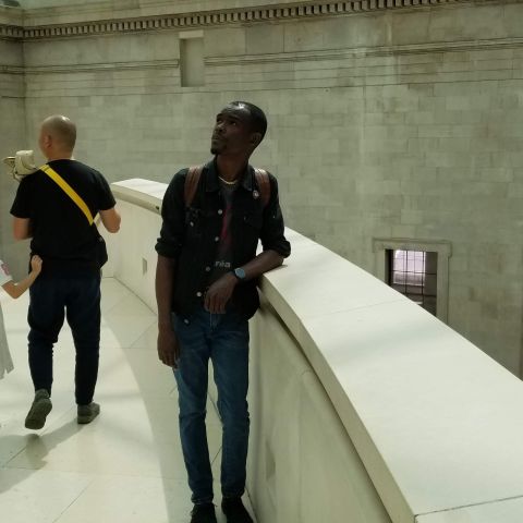 Artist Eustace Mamba stands on top of marble balcony