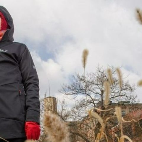 Credit: Fairmount Park Conservancy; Sarah McEneaney stands in tall grasses at Reading Viaduct Project