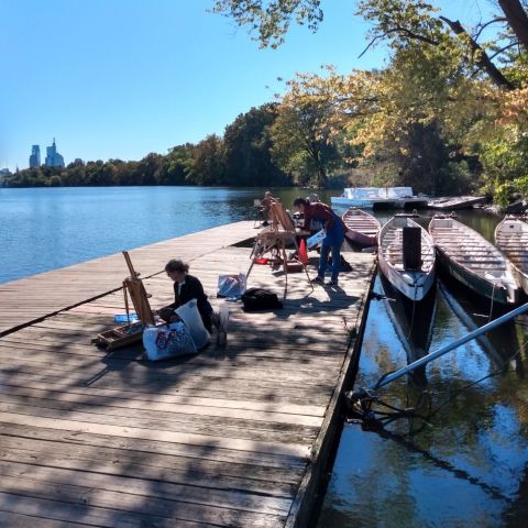 Students painting on river doc