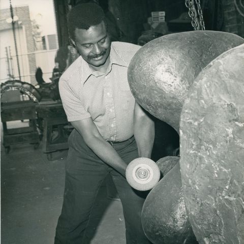 Black and white image of John Rhoden sculpting