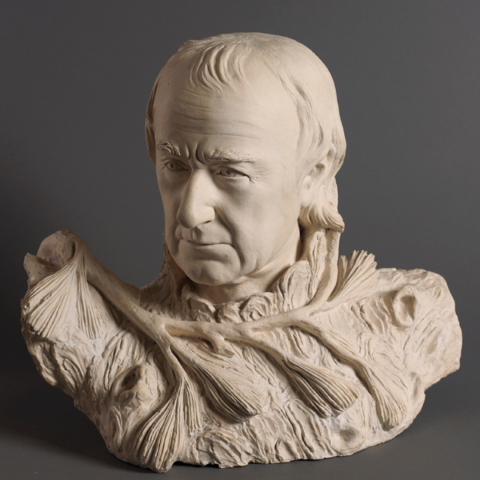 A terracotta self-portrait by American neoclassical sculptor William Rush (ca. 1822) depicts a middle-aged man emerging from a base of rough-hewn wood and pine branches.
