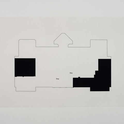 An architectural floor plan rendered in minimalist black and white, featuring a large, symmetrical building outline with two prominent blacked-out areas labeled with the word 'Shop.'