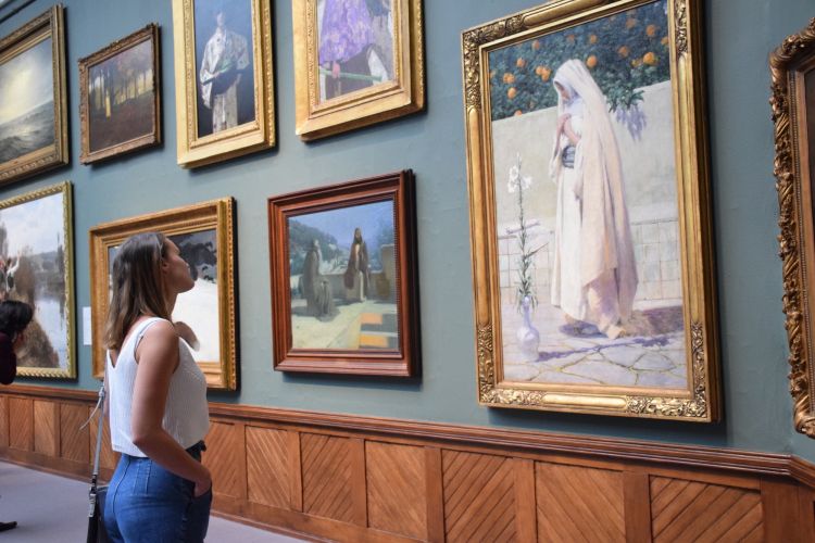 a student looks at work in the museum
