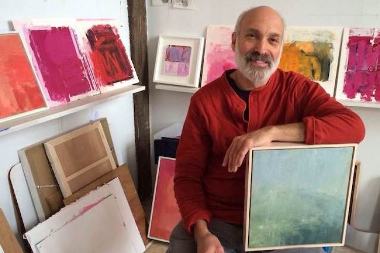 Instructor Stuart Shils with his paintings