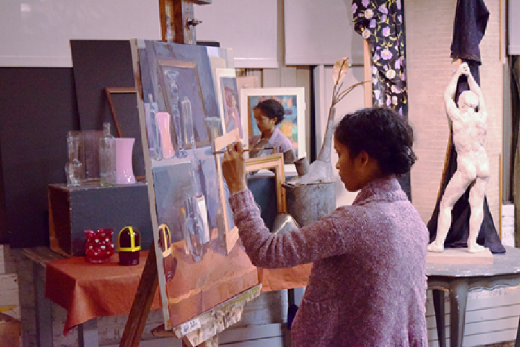 Student painting a still life