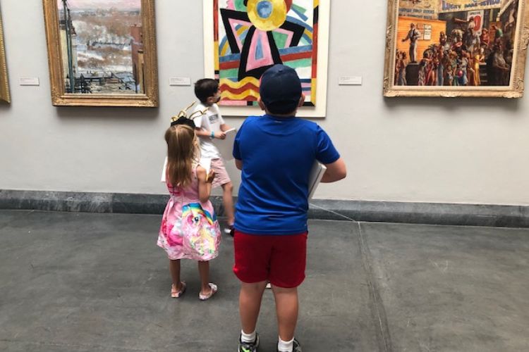 Children looking at the painting in museum gallery