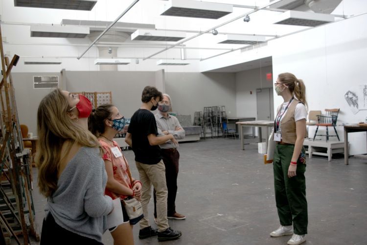 students standing in a large classroom on campus tour
