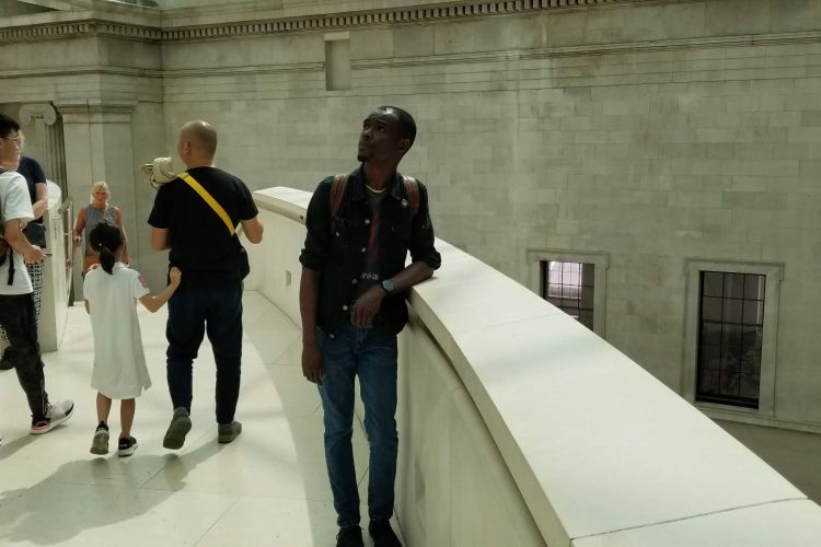 Artist Eustace Mamba stands on top of marble balcony