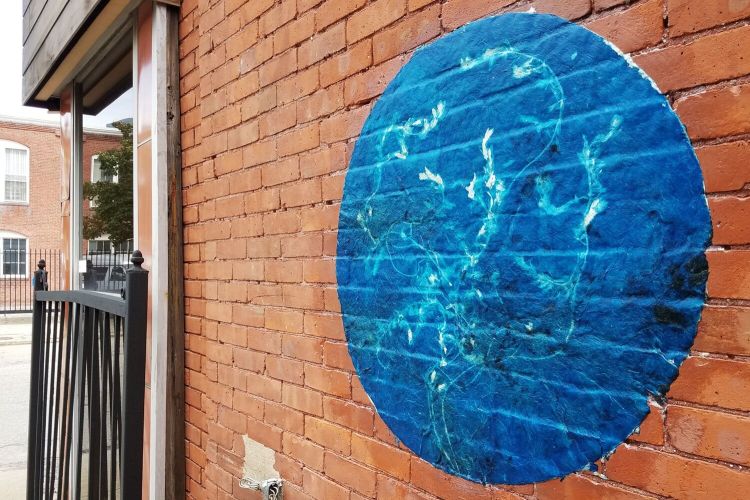 May Babcock, Blackstone Watershed Papers, 2018, wheat-pasted cyanotype on artist-made paper from water chestnut (Trapa natans), Japanese knotweed (Fallopia japonica), Eurasian milfoil (Myriophyllum spicatum), cotton waste scrap, abaca, 36 inches in diameter. Image courtesy of the artist, © 2022 May Babcock. 