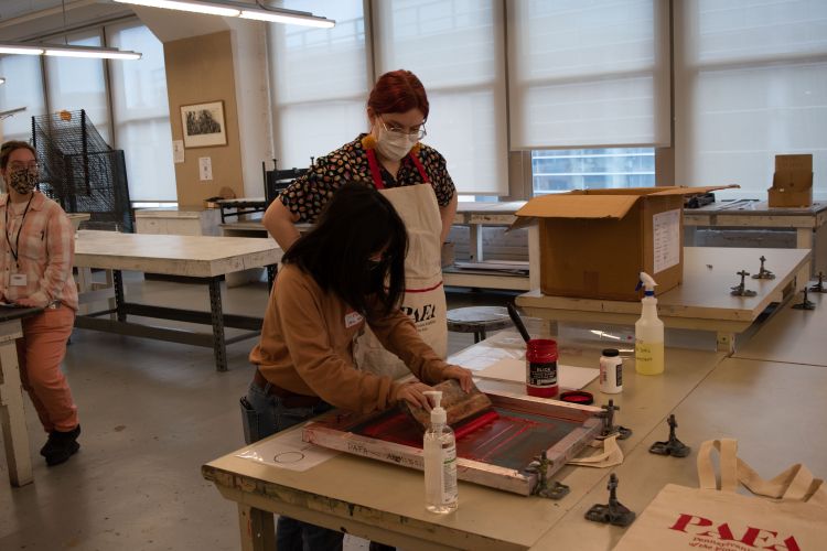 A student printing their own PAFA tote bag on a previous Preview Day.