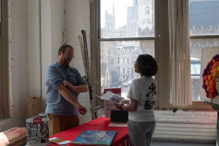 A student and a PAFA Admissions Counselor in a portfolio review.