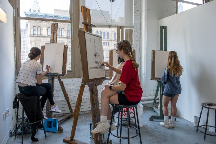 Teens drawing skyline