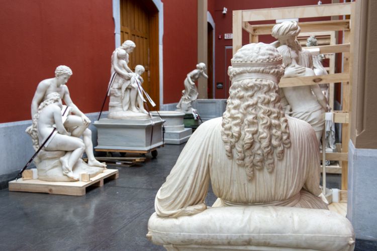 marble statues on wood pallets