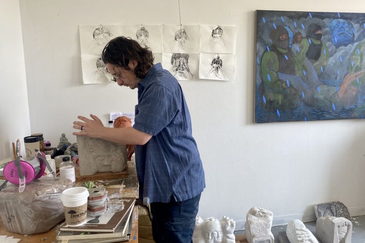 Eric Wagner in his studio sharing marble sculpture