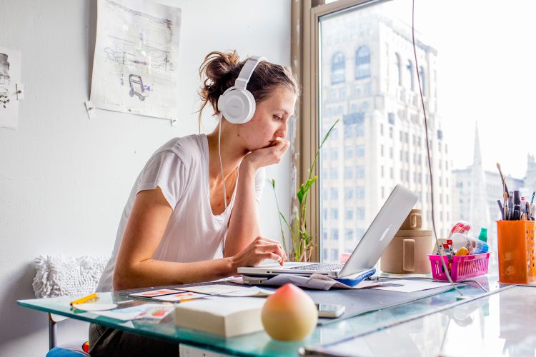 student on computer in studio