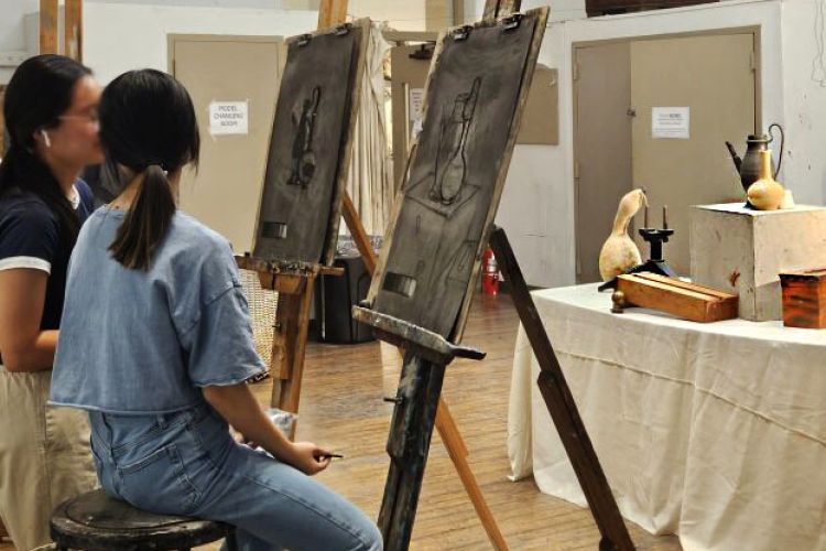 students in studio with easels