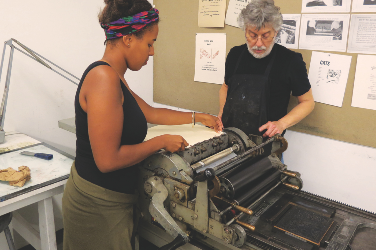 Tony Rosati and Student working the letter press