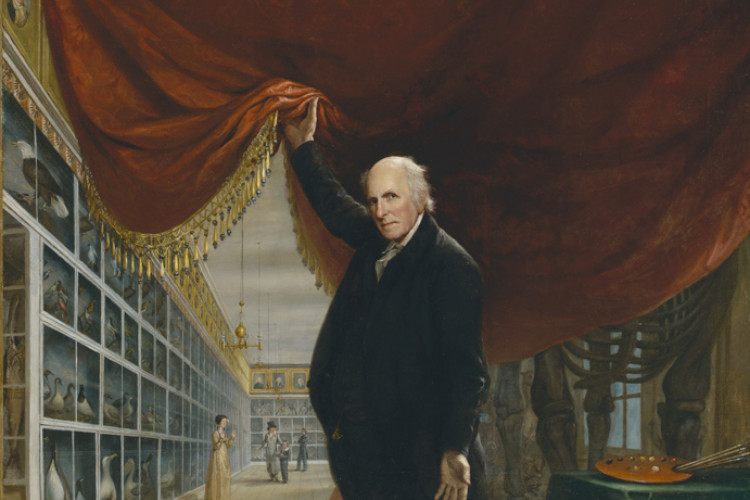 An elderly man in a black suit lifts a heavy red velvet curtain to reveal a long museum gallery filled with rows of taxidermy birds and a large mastodon skeleton.