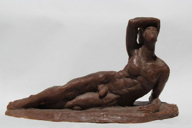 Figure posed laying down while holding themselves up on one side, the other arm relaxed on their head