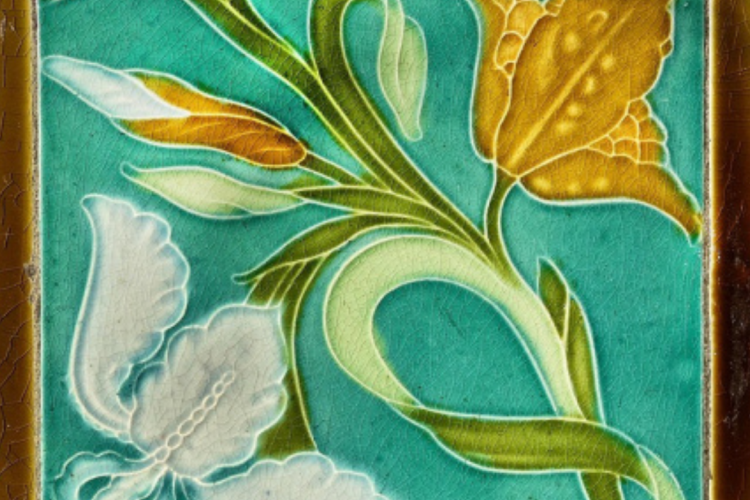 An Art Nouveau-style ceramic tile featuring embossed, swirling floral motifs in shades of white, yellow, and green set against a vibrant teal background.