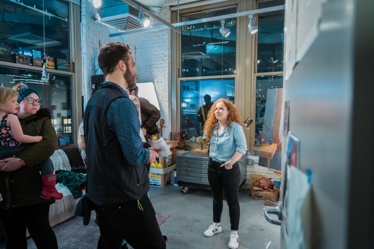 Student showing visitors their PAFA studio.